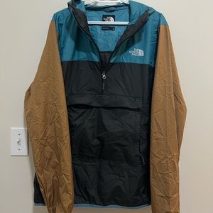 The Northface Stowable Mens lightweight trail windbreaker.